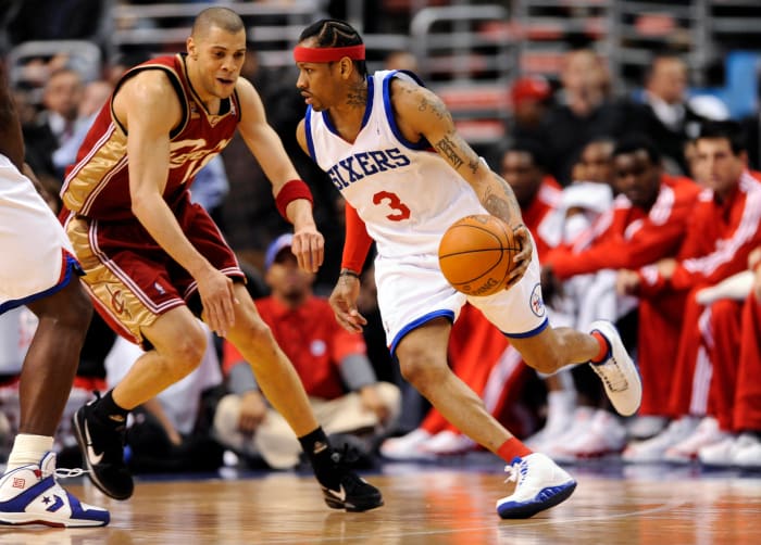 Philadelphia 76ers guard Allen Iverson dribbles by Cleveland Cavaliers guard Anthony Parker.